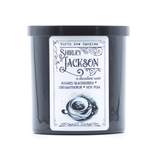 a Shirley Jackson book  candle in a black jar